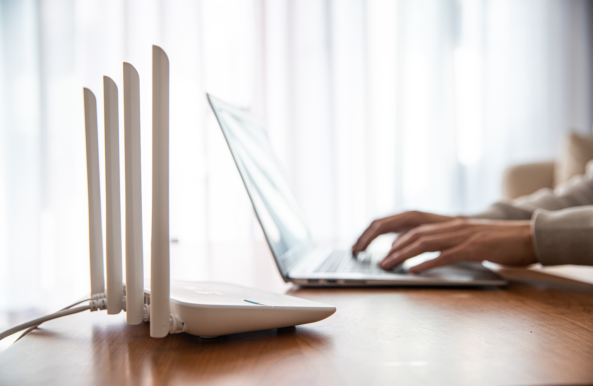 Internet router with man working on laptop